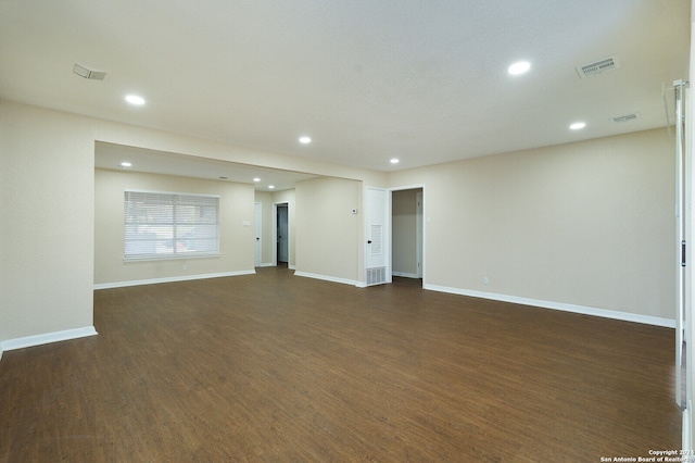 spare room with dark hardwood / wood-style flooring