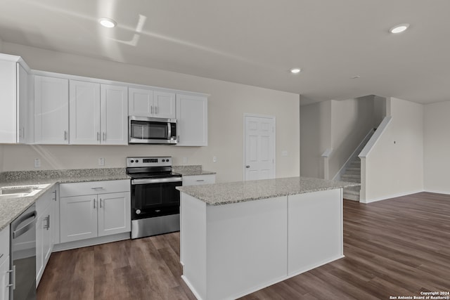 kitchen with white cabinetry, dark wood-type flooring, and stainless steel appliances