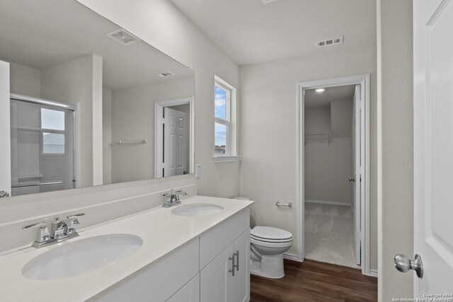 bathroom featuring hardwood / wood-style floors, vanity, and toilet