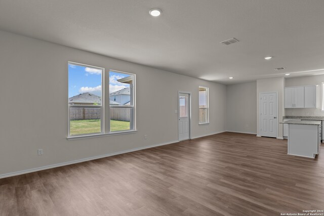 unfurnished living room featuring wood-type flooring