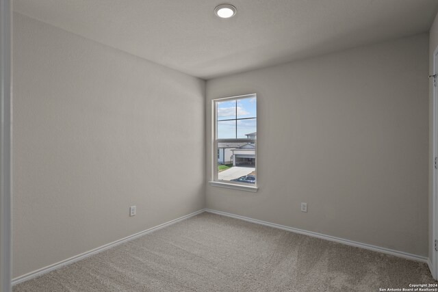 empty room with carpet flooring