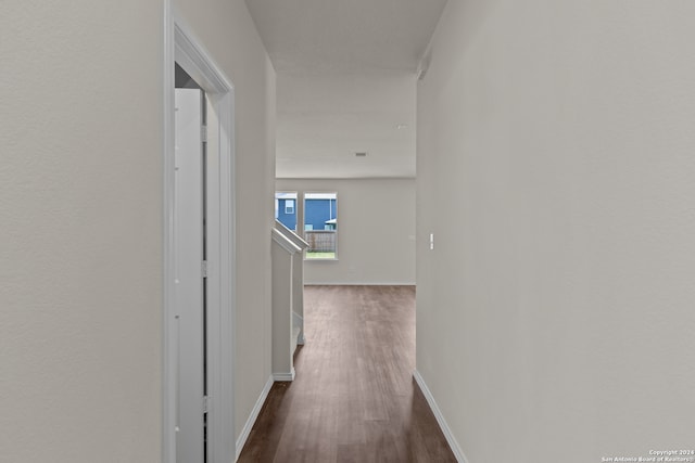 hallway featuring dark hardwood / wood-style flooring