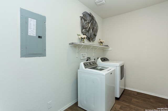 laundry area with electric panel, dark wood-type flooring, and washing machine and dryer