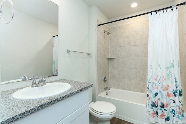 full bathroom with vanity, hardwood / wood-style floors, toilet, and shower / bath combo