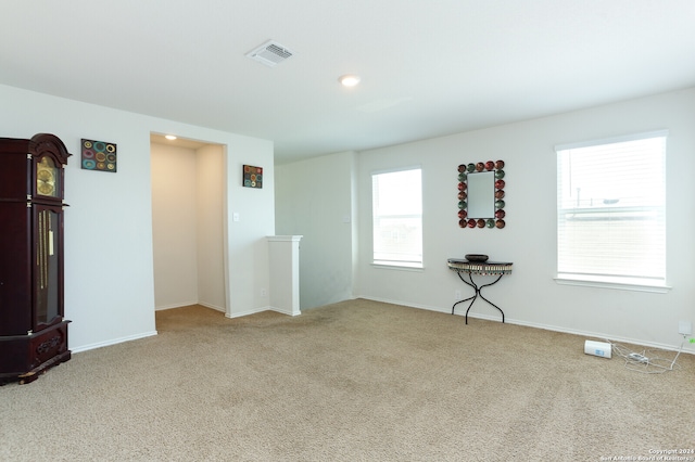 spare room featuring light colored carpet