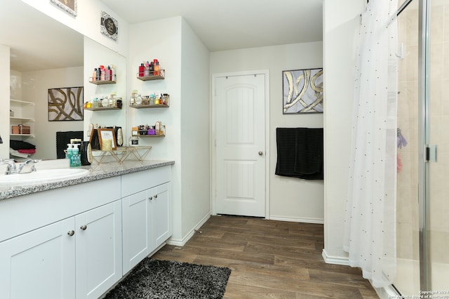 bathroom with a shower with shower curtain, wood-type flooring, and vanity