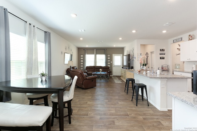 dining area featuring sink and hardwood / wood-style floors