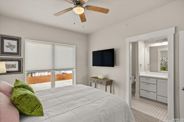 bedroom with light carpet, ceiling fan, and ensuite bathroom