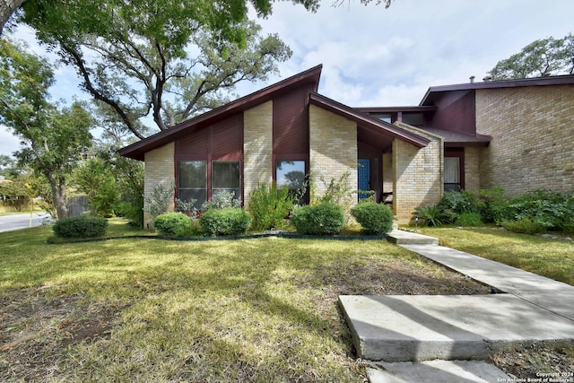 view of side of property with a lawn