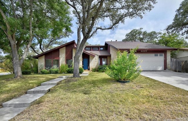 view of front of property with a garage and a front lawn