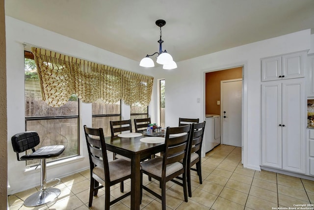 tiled dining area with a chandelier