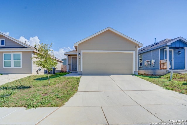 ranch-style house featuring a garage and a front lawn