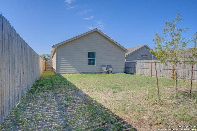 back of house with a lawn