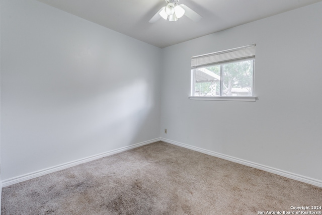 empty room featuring carpet floors and ceiling fan