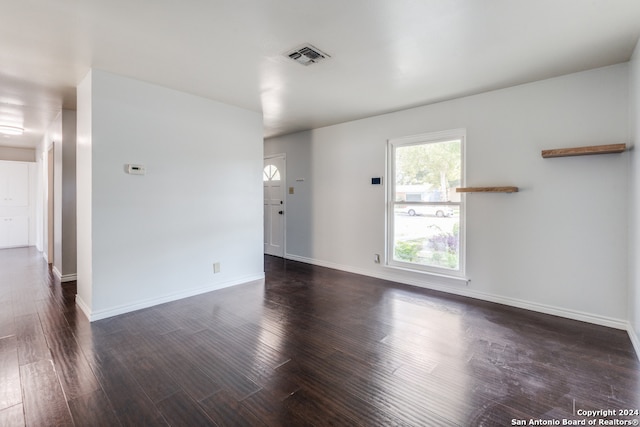 empty room featuring dark wood-type flooring