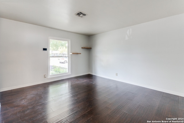 spare room with dark hardwood / wood-style flooring