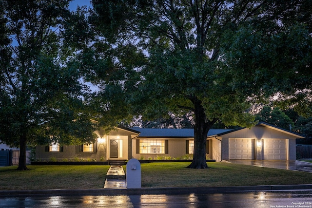 view of front of property featuring a garage and a front lawn