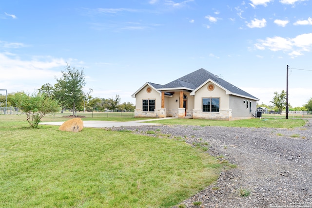 view of front of property with a front lawn and central air condition unit