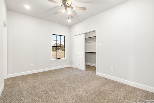 unfurnished bedroom with a closet, ceiling fan, and carpet flooring