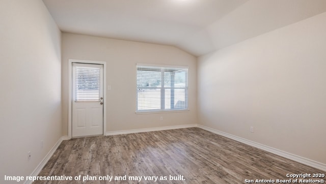 unfurnished room with wood-type flooring and vaulted ceiling