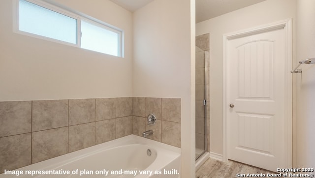 bathroom featuring independent shower and bath and wood-type flooring