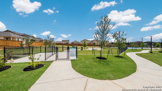 view of home's community with a yard and a water view