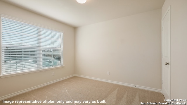 unfurnished room with light colored carpet