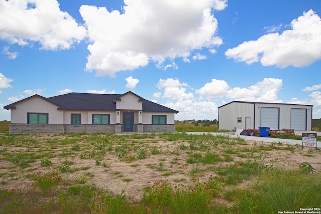 back of property with an outbuilding and a garage