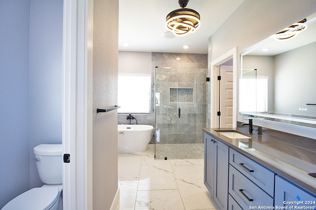 full bathroom with vanity, toilet, and separate shower and tub