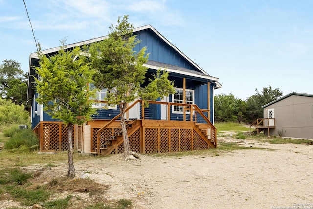 back of property featuring a wooden deck