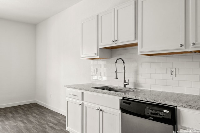 kitchen featuring light stone counters, white cabinets, sink, stainless steel dishwasher, and hardwood / wood-style flooring