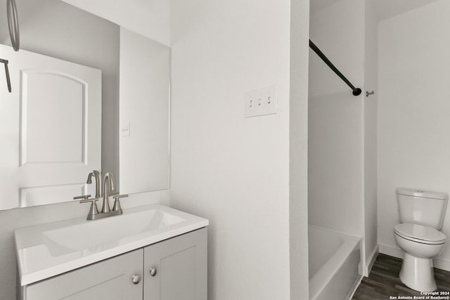 bathroom featuring hardwood / wood-style floors, vanity, and toilet