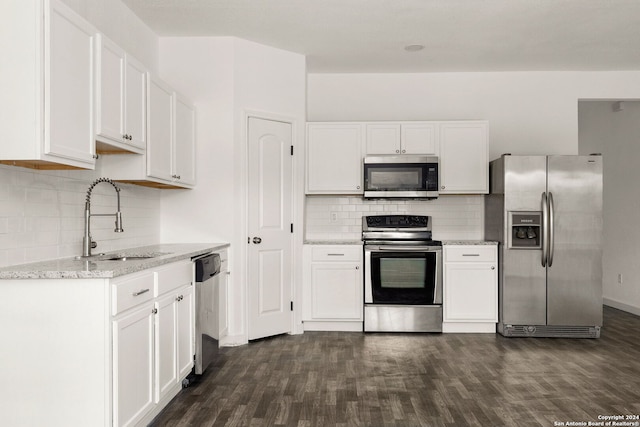 kitchen featuring sink, white cabinets, appliances with stainless steel finishes, dark hardwood / wood-style flooring, and light stone countertops