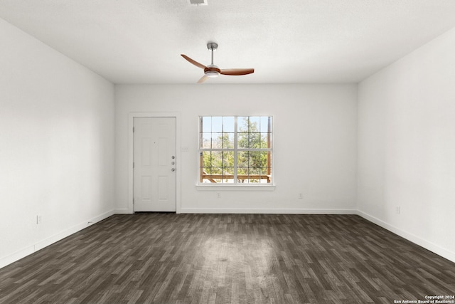 spare room with ceiling fan and dark hardwood / wood-style flooring