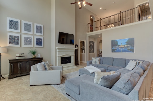 living room with a high ceiling and ceiling fan