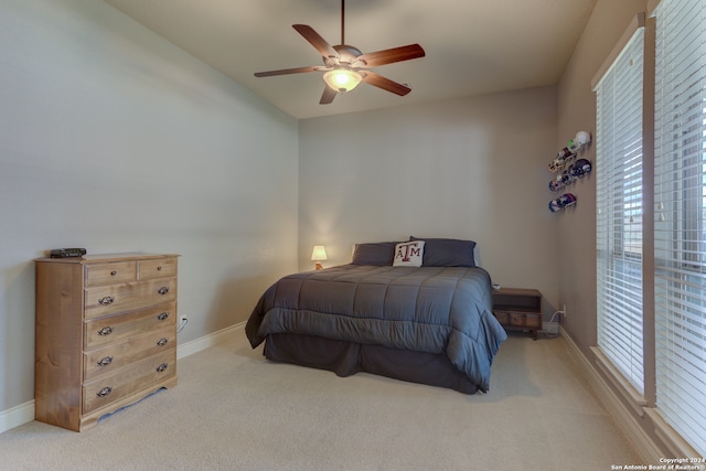 bedroom featuring ceiling fan and light colored carpet