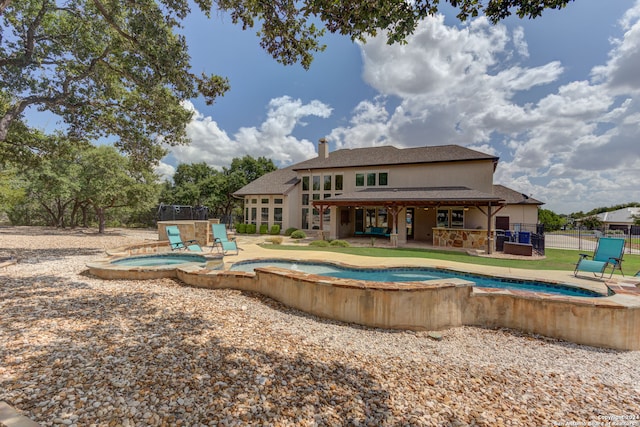 view of pool with a patio and an in ground hot tub