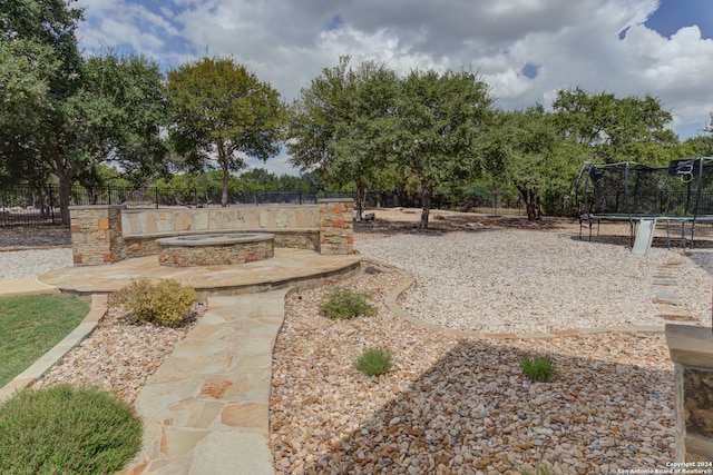 view of yard featuring a trampoline and a patio area