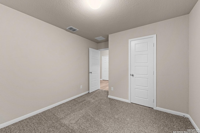 unfurnished bedroom with carpet and a textured ceiling