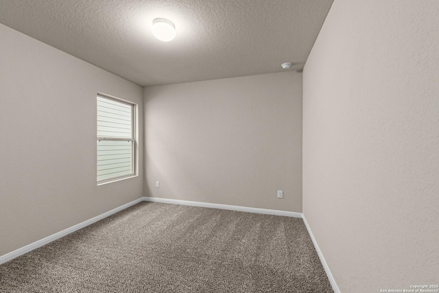 unfurnished room featuring a textured ceiling and carpet