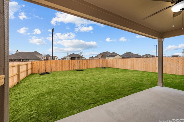 view of yard with a patio and ceiling fan