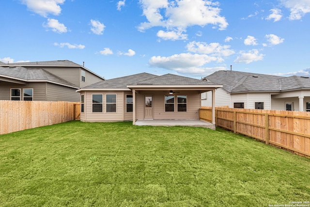 rear view of property featuring a patio, a yard, and ceiling fan