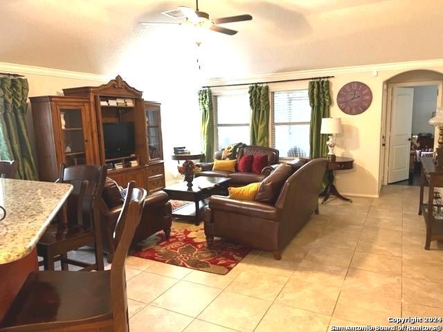 living room with ceiling fan and light tile patterned floors