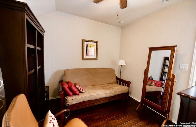 interior space featuring ceiling fan, vaulted ceiling, and dark wood-type flooring