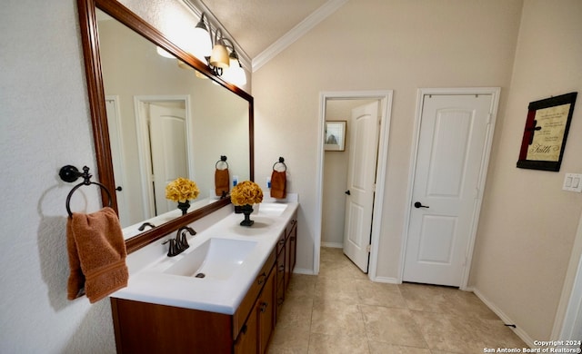 bathroom with tile patterned flooring, a textured ceiling, lofted ceiling, ornamental molding, and vanity