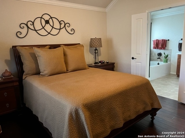 bedroom featuring hardwood / wood-style flooring and ornamental molding