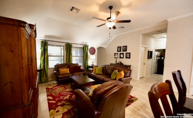 tiled living room featuring ornamental molding, lofted ceiling, ceiling fan, and a textured ceiling