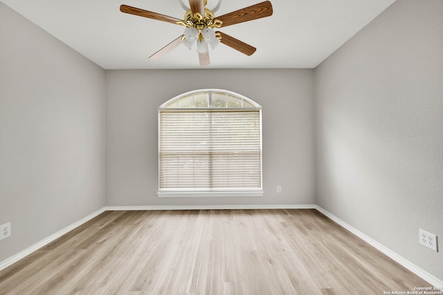 empty room with light hardwood / wood-style floors and ceiling fan