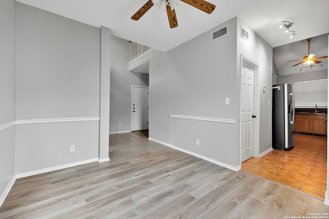 interior space featuring high vaulted ceiling, sink, ceiling fan, and light hardwood / wood-style flooring