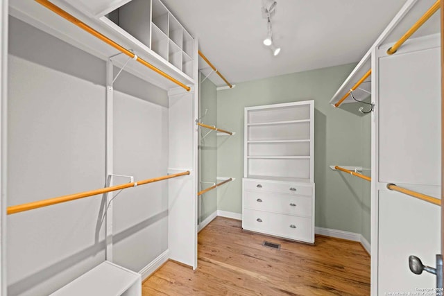 spacious closet featuring light wood-type flooring